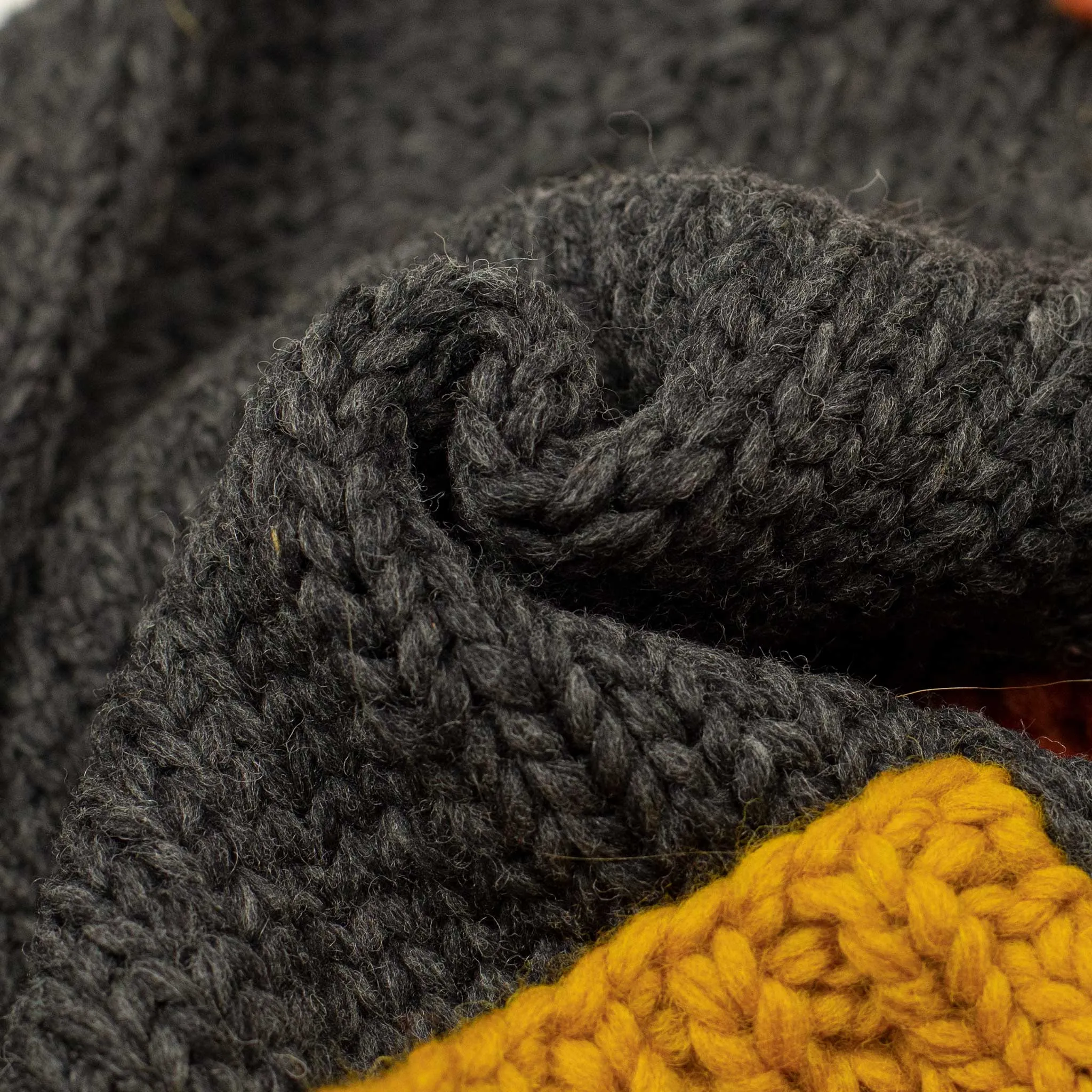 Exclusive hand-knit Cowichan cardigan in charcoal, orange, yellow and teal 6-ply, wool